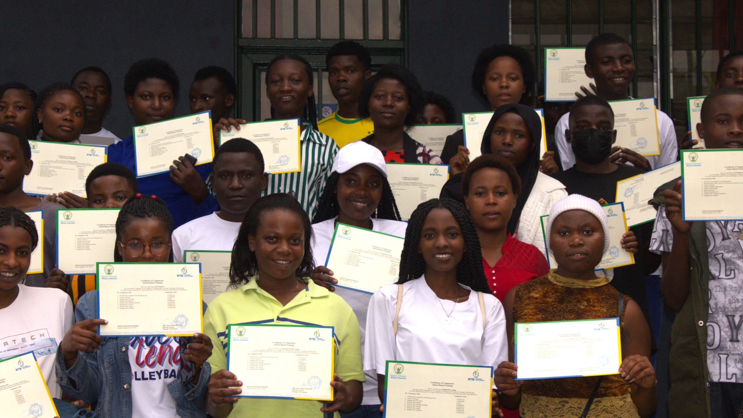 Young graduates holding their certificates after completing a Vision Jeunesse Nouvelle training programme