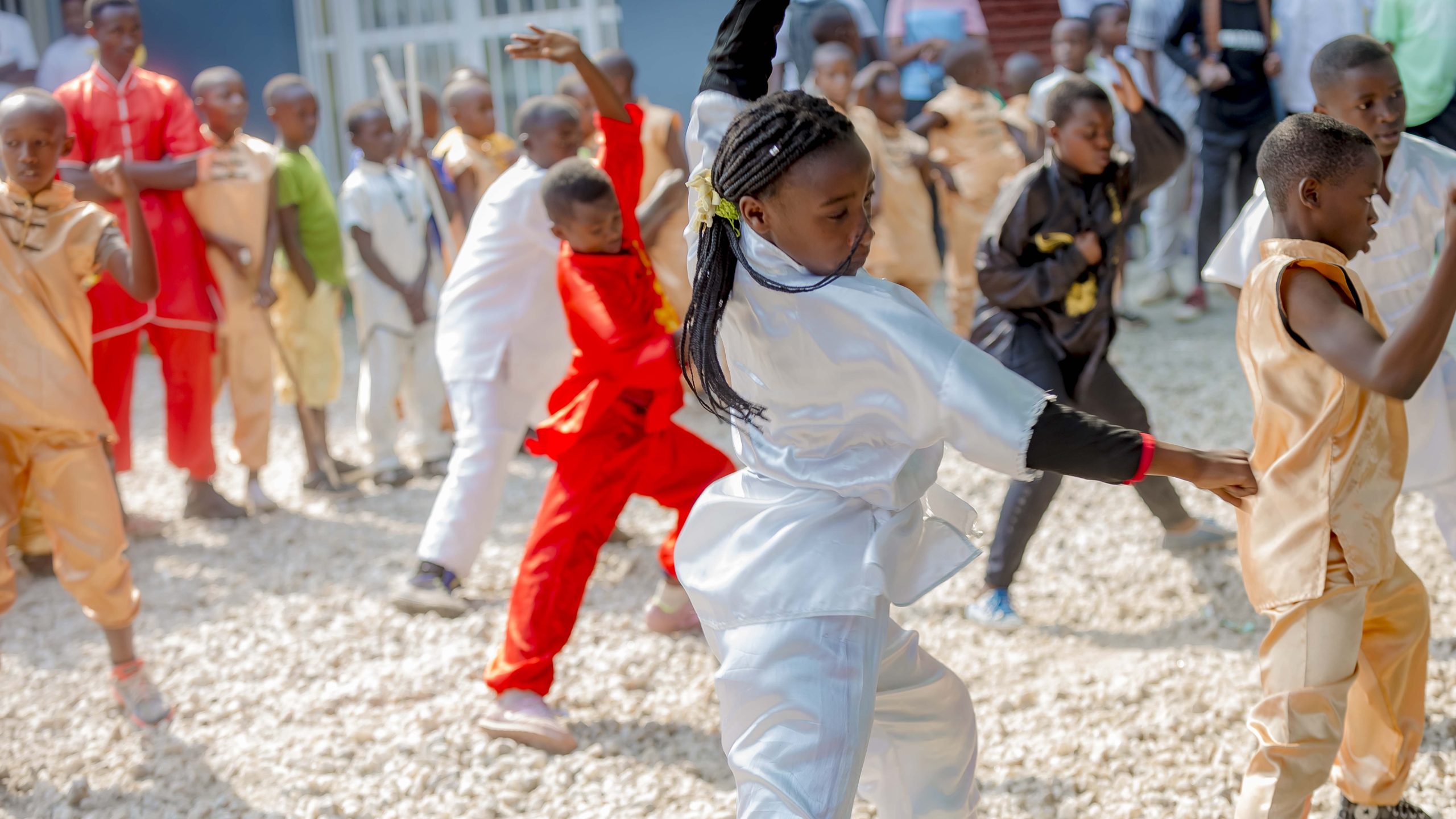 Young martial arts students in uniform performing a karate demonstration at a Vision Jeunesse Nouvelle event