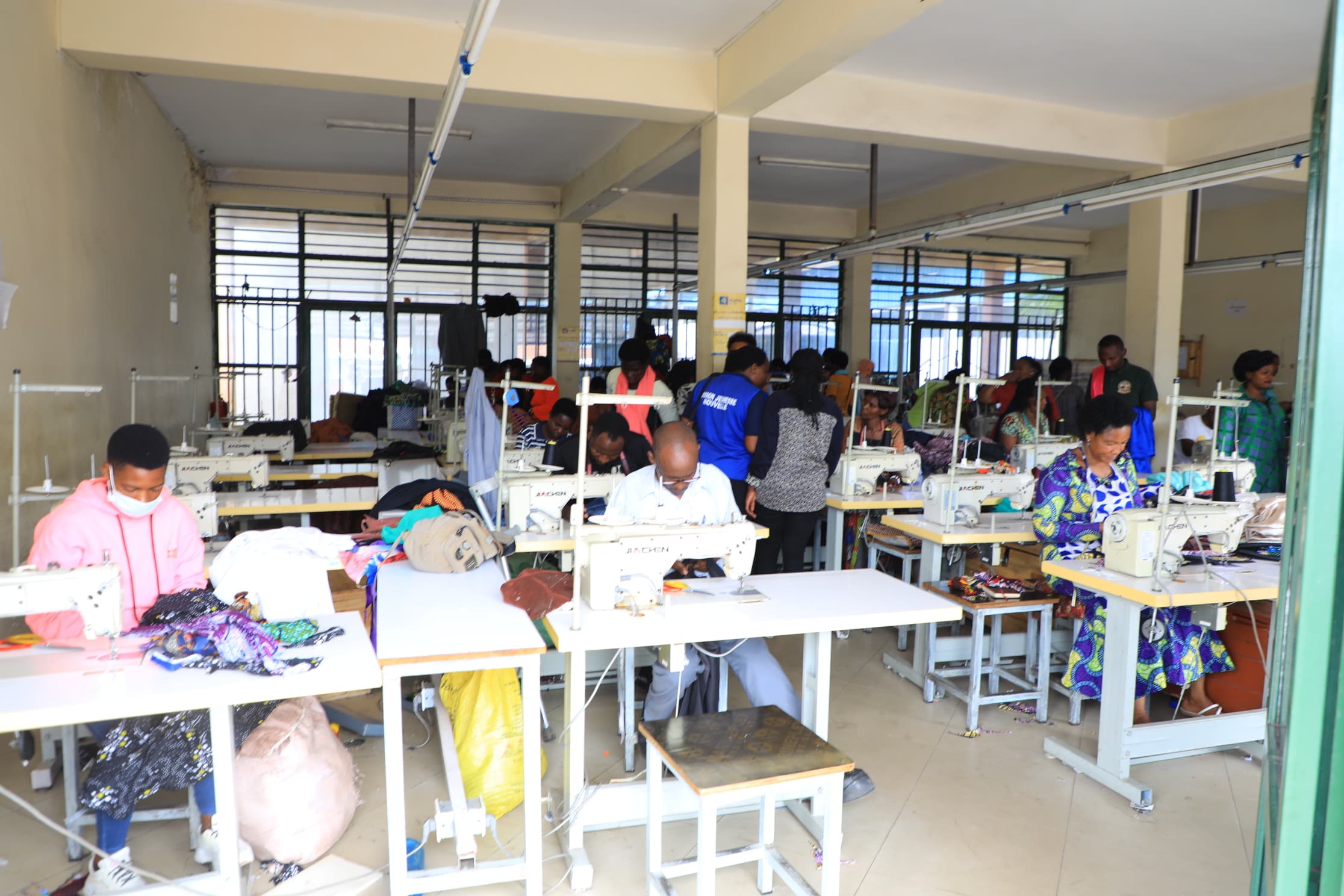 Grace Uwase working with young tailoring apprentices in her workshop